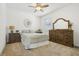 Serene bedroom with a ceiling fan, a neutral palette, and a large dresser at 17226 Hickory Wind Dr, Clermont, FL 34711