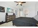 Comfortable bedroom featuring a ceiling fan, a large window and closet, light carpet, and sleek, dark furniture at 17226 Hickory Wind Dr, Clermont, FL 34711