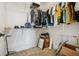 Walk-in closet with white shelving, filled with clothing and shoes at 17226 Hickory Wind Dr, Clermont, FL 34711
