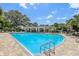 Community pool with lounging area and trees at 17226 Hickory Wind Dr, Clermont, FL 34711