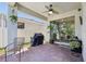 Relaxing covered patio with brick pavers, ceiling fan, and sliding glass doors to the interior at 17226 Hickory Wind Dr, Clermont, FL 34711