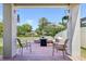 Inviting covered patio with brick pavers, comfortable seating, and a view of the landscaped front yard at 17226 Hickory Wind Dr, Clermont, FL 34711