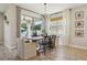 Bright dining area with natural light, an elegant chandelier, and backyard view at 17226 Hickory Wind Dr, Clermont, FL 34711