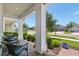 Inviting front porch with comfortable seating and a view of the well-maintained neighborhood at 17226 Hickory Wind Dr, Clermont, FL 34711