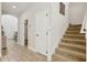 Inviting hallway with wood-look tile flooring and staircase leading to the second floor at 17226 Hickory Wind Dr, Clermont, FL 34711
