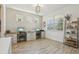 Well-lit home office featuring two work stations, decor shelves, and wood-look flooring at 17226 Hickory Wind Dr, Clermont, FL 34711