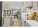Well-lit kitchen showcases stainless steel appliances, an island, and subway tile backsplash at 17226 Hickory Wind Dr, Clermont, FL 34711