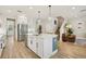 Spacious kitchen boasts an island with sink, stainless steel appliances, and wood-look tile flooring at 17226 Hickory Wind Dr, Clermont, FL 34711