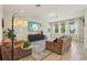 Comfortable living room filled with natural light and a large TV at 17226 Hickory Wind Dr, Clermont, FL 34711