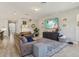 Spacious living room features hardwood floors, comfortable furniture, and a large television at 17226 Hickory Wind Dr, Clermont, FL 34711