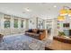 Bright living room with hardwood floors, a modern kitchen, and comfortable leather furniture at 17226 Hickory Wind Dr, Clermont, FL 34711