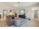 Open living room layout with wood-look tile flooring and a modern TV at 17226 Hickory Wind Dr, Clermont, FL 34711