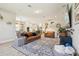 Open concept living room with lots of natural light, hardwood floors, and comfortable leather furniture at 17226 Hickory Wind Dr, Clermont, FL 34711