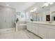 Beautiful main bathroom with walk-in shower, soaking tub, and double vanity sinks at 17226 Hickory Wind Dr, Clermont, FL 34711