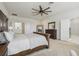 Bright main bedroom with ensuite bathroom, carpet, and a ceiling fan at 17226 Hickory Wind Dr, Clermont, FL 34711