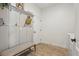 Mud room featuring convenient hooks and bench, next to the laundry area at 17226 Hickory Wind Dr, Clermont, FL 34711