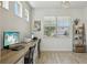 Functional office space featuring wood-look tile flooring, a built-in desk with drawers and open shelving at 17226 Hickory Wind Dr, Clermont, FL 34711