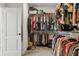 Spacious walk-in closet with ample storage on shelves and hanging racks, perfect for organizing any wardrobe at 17226 Hickory Wind Dr, Clermont, FL 34711