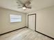 Bedroom featuring ceiling fan, wood-look flooring, and spacious closet at 2007 N Hastings St, Orlando, FL 32808
