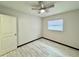 This is a bedroom with light grey wood-look floors and a white painted door at 2007 N Hastings St, Orlando, FL 32808