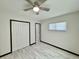 Bedroom featuring ceiling fan, wood-look flooring, and spacious closet at 2007 N Hastings St, Orlando, FL 32808