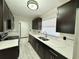 Modern kitchen featuring dark cabinets, marble-style countertops, and stainless steel appliances at 2007 N Hastings St, Orlando, FL 32808