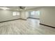 A spacious living area with light wood floors, recessed lighting, and ceiling fans at 2007 N Hastings St, Orlando, FL 32808