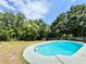 The pool features landscaping for additional privacy and a concrete deck at 2007 N Hastings St, Orlando, FL 32808