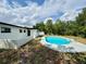 The in-ground pool is surrounded by landscaping for additional privacy at 2007 N Hastings St, Orlando, FL 32808