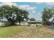 Expansive backyard featuring a pergola, swing, and mature trees, offering a serene outdoor setting at 205 Sanora Blvd, Sanford, FL 32773