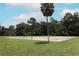 Outdoor community basketball court surrounded by a grassy lawn and mature trees at 205 Sanora Blvd, Sanford, FL 32773