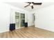 Bright bedroom featuring wood-look floors, sliding glass door to back patio, and ceiling fan at 205 Sanora Blvd, Sanford, FL 32773