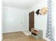 Bright foyer with light wood flooring, a white rug and walls and storage bench by the front door at 205 Sanora Blvd, Sanford, FL 32773