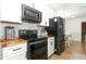 This kitchen features modern black appliances, butcher block countertops, and white cabinets at 205 Sanora Blvd, Sanford, FL 32773