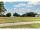 View of a grassy lot ready for building with a paved sidewalk at 205 Sanora Blvd, Sanford, FL 32773