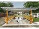 Relaxing backyard pergola with a table and bench seating, ideal for enjoying outdoor space at 205 Sanora Blvd, Sanford, FL 32773