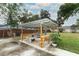 Backyard pergola with seating and plants, creating a cozy outdoor retreat at 205 Sanora Blvd, Sanford, FL 32773