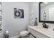 Nautical-themed bathroom featuring a white vanity, black hardware, and stylish decor for a fresh, clean look at 2117 Stone Abbey Blvd, Orlando, FL 32828