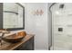 Bathroom features a unique vessel sink, wood vanity, and glass shower at 2117 Stone Abbey Blvd, Orlando, FL 32828