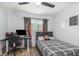This bedroom features a comfortable bed and desk for working or studying at 2117 Stone Abbey Blvd, Orlando, FL 32828