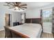 The bedroom showcases wood-look flooring and a ceiling fan, with an ensuite bathroom at 2117 Stone Abbey Blvd, Orlando, FL 32828