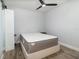 A simple bedroom with laminate flooring, a modern ceiling fan, and a bed frame at 2117 Stone Abbey Blvd, Orlando, FL 32828
