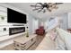 Comfortable living room features a modern fireplace, mounted TV, plush sofa, and ceiling fan at 2117 Stone Abbey Blvd, Orlando, FL 32828