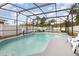 The property includes a screened pool with patio seating and backyard views at 2117 Stone Abbey Blvd, Orlando, FL 32828
