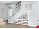 Unique staircase with a dog-friendly gate underneath, complemented by modern decor and wood-look flooring at 2117 Stone Abbey Blvd, Orlando, FL 32828