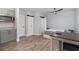 Well-lit studio with kitchenette, stainless appliances, and light wood-look flooring at 2117 Stone Abbey Blvd, Orlando, FL 32828