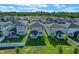 Aerial view of backyards featuring well-maintained lawns and covered patios, perfect for relaxation at 2304 Mystic Maze Ln, Clermont, FL 34715
