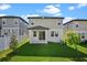 The backyard boasts a lush lawn, partial fence, and a covered patio for outdoor enjoyment at 2304 Mystic Maze Ln, Clermont, FL 34715