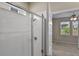Bathroom boasts a tiled shower with a glass door and a view into the bedroom at 2304 Mystic Maze Ln, Clermont, FL 34715