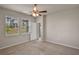 Inviting bedroom with carpeted flooring, windows for natural light, and a ceiling fan for added comfort at 2304 Mystic Maze Ln, Clermont, FL 34715